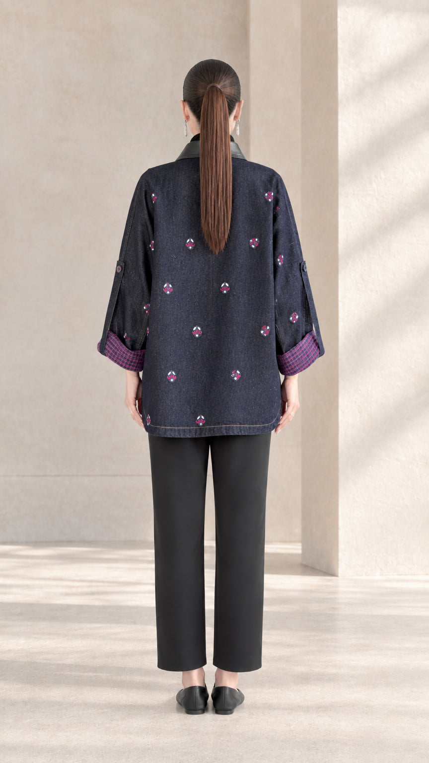 Back view of Indigo Blue embroidered jacket showing high-low curved hemline