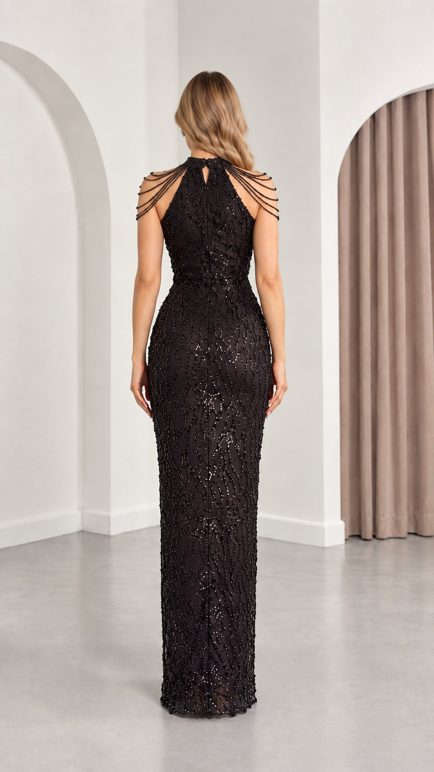 Back view of black sequined maxi dress highlighting high neck keyhole and beaded shoulders