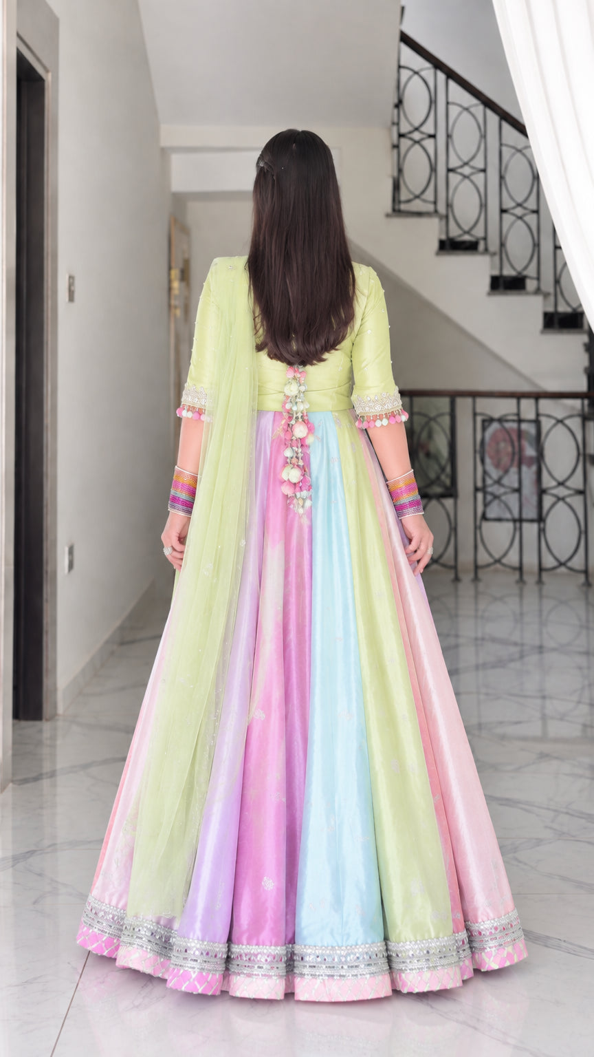 Back view of lime green multicolor Anarkali gown with back tassel tie detail