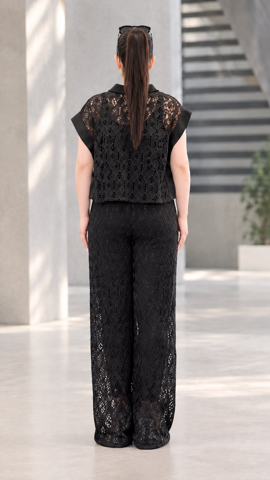 Back full-length view of black lace collared blouse and flowing wide-leg pants