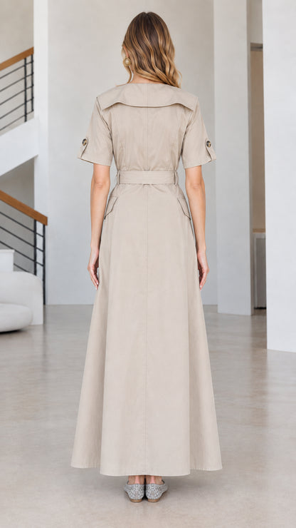 Back view of beige short-sleeve trench maxi dress with wide collar and belt