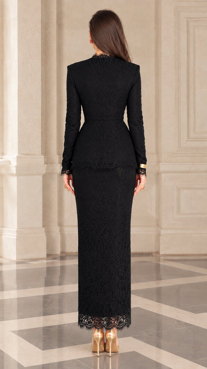 Back view of model wearing full-length black lace skirt and tailored peplum top