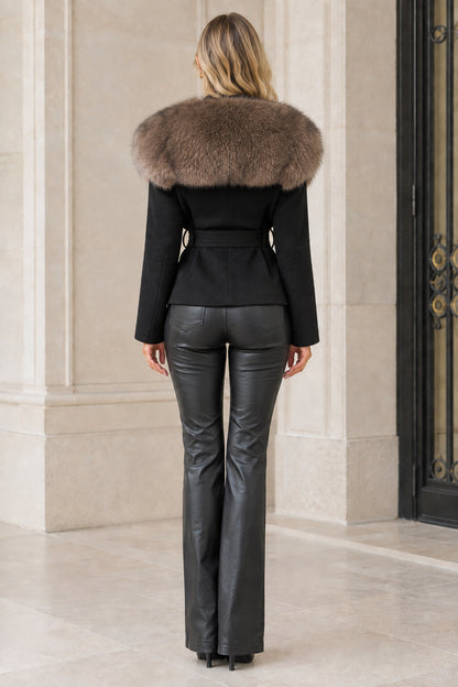 Back view of model wearing black tailored jacket with faux fur collar