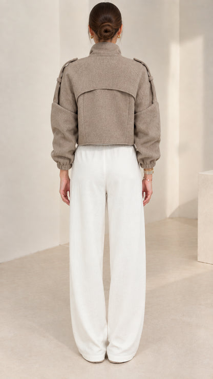 Back view of taupe cropped zip-up jacket highlighting clean back yoke design