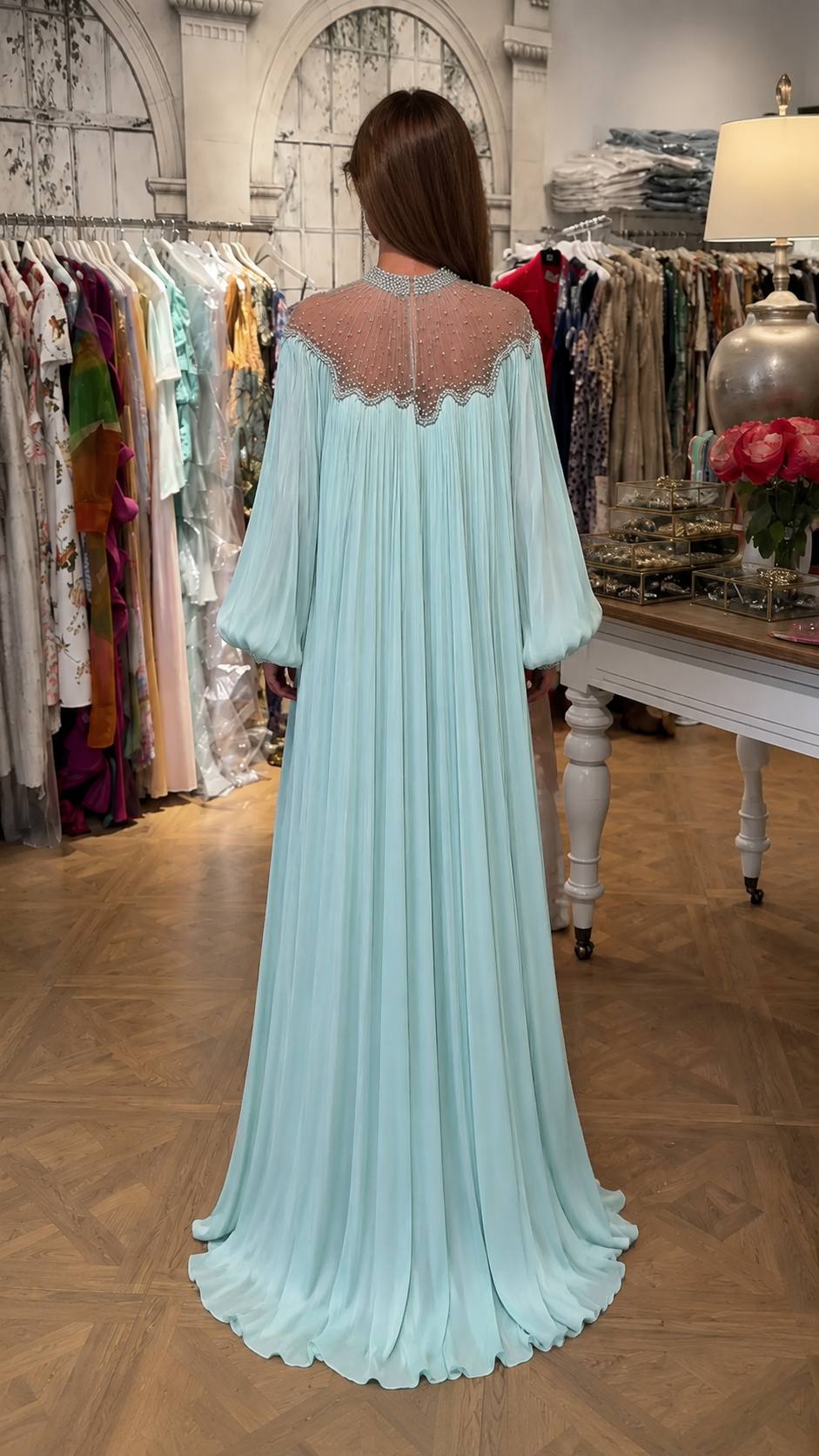 Back view of ice blue maxi dress with sheer embellished upper back and full pleated skirt