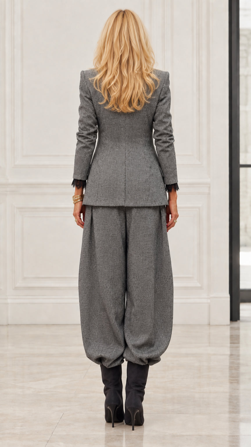 Back view of model in Grey textured blazer and tapered trousers