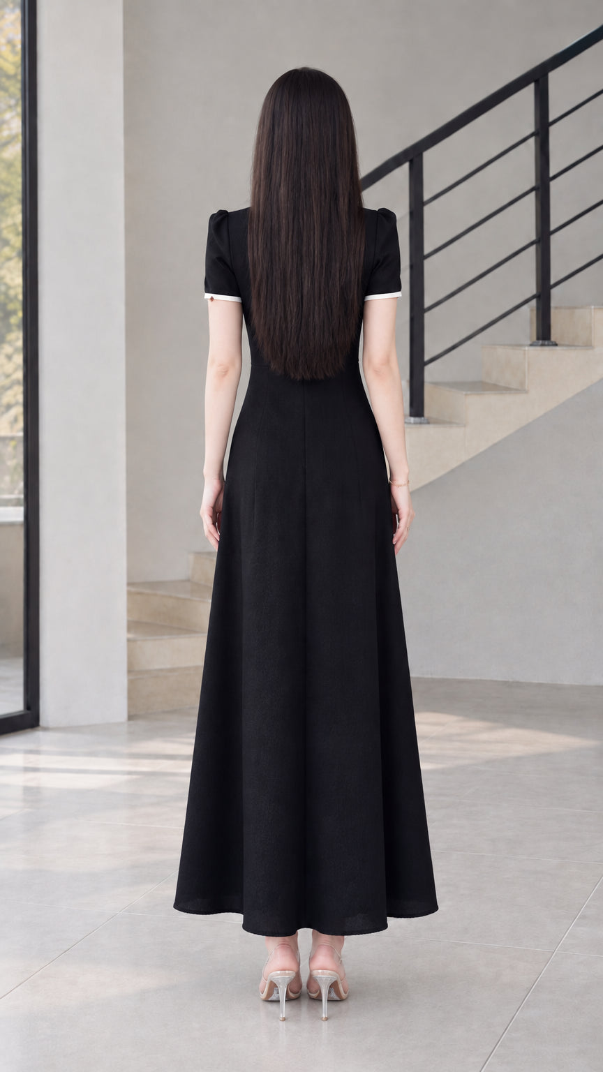 Back view of black modern cheongsam maxi dress showing clean silhouette
