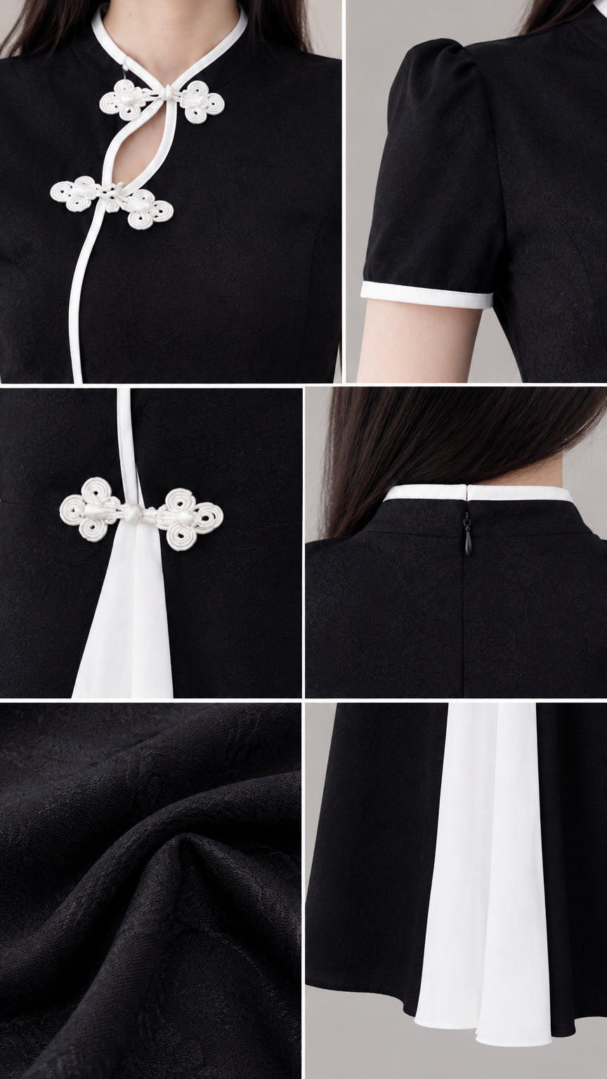Detail view of mandarin collar, frog buttons, cuff trim, and textured fabric