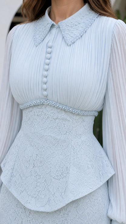 Close-up of embellished collar, pleated bodice, and beaded peplum waist