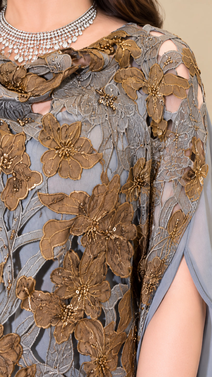 Close-up detail of golden floral lace embroidery and beadwork on dusty blue gown