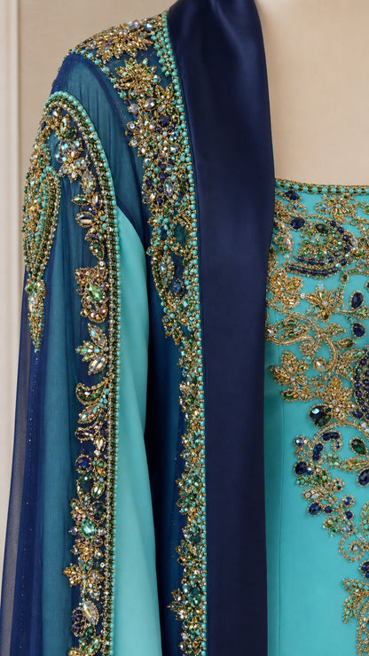 Close-up detail of intricate crystal beadwork, sequins, and embroidery on bodice and cape