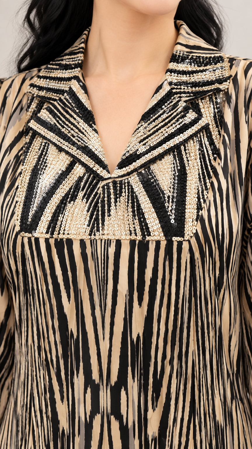 Close-up of sequin embellishments and notched lapel on printed maxi dress