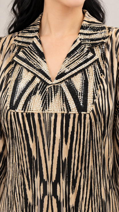 Close-up of sequin embellishments and notched lapel on printed maxi dress