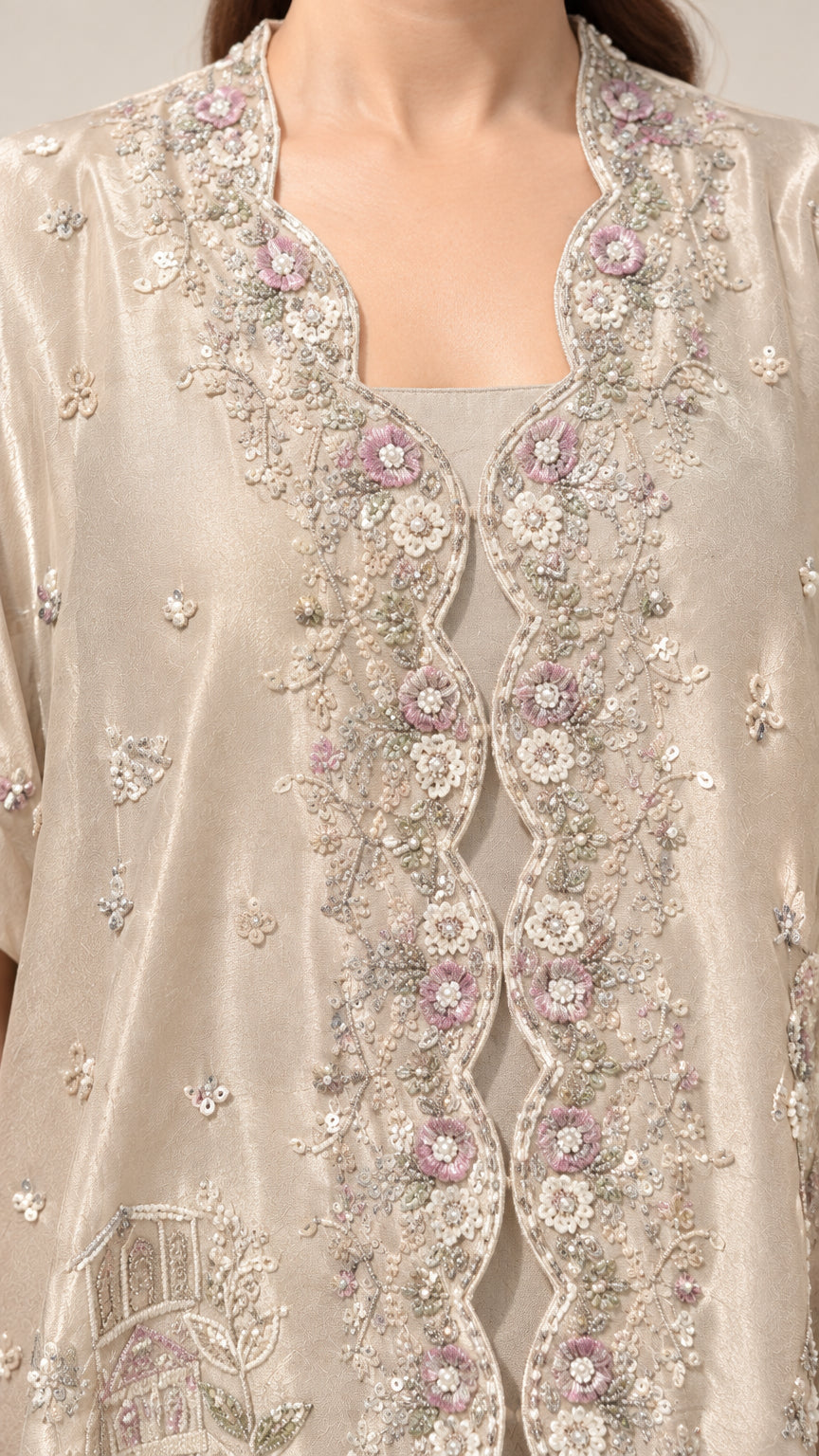 Close-up of intricate floral embroidery and beadwork on the champagne neckline and bodice