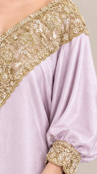 Close-up of gold floral sequin and bead embroidery on lilac dress cuff and neckline