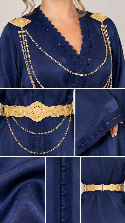 Close-up details of gold shoulder chains, waist belt, and scalloped neckline trim on navy satin