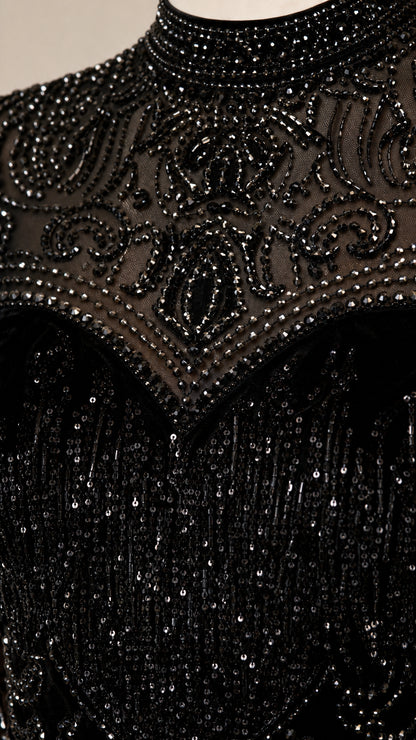 Close-up detail of sheer illusion high neck with ornate beading and sequins