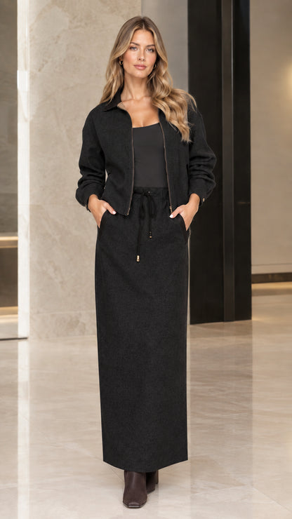 Model wearing Black two-piece zip jacket and drawstring maxi skirt set