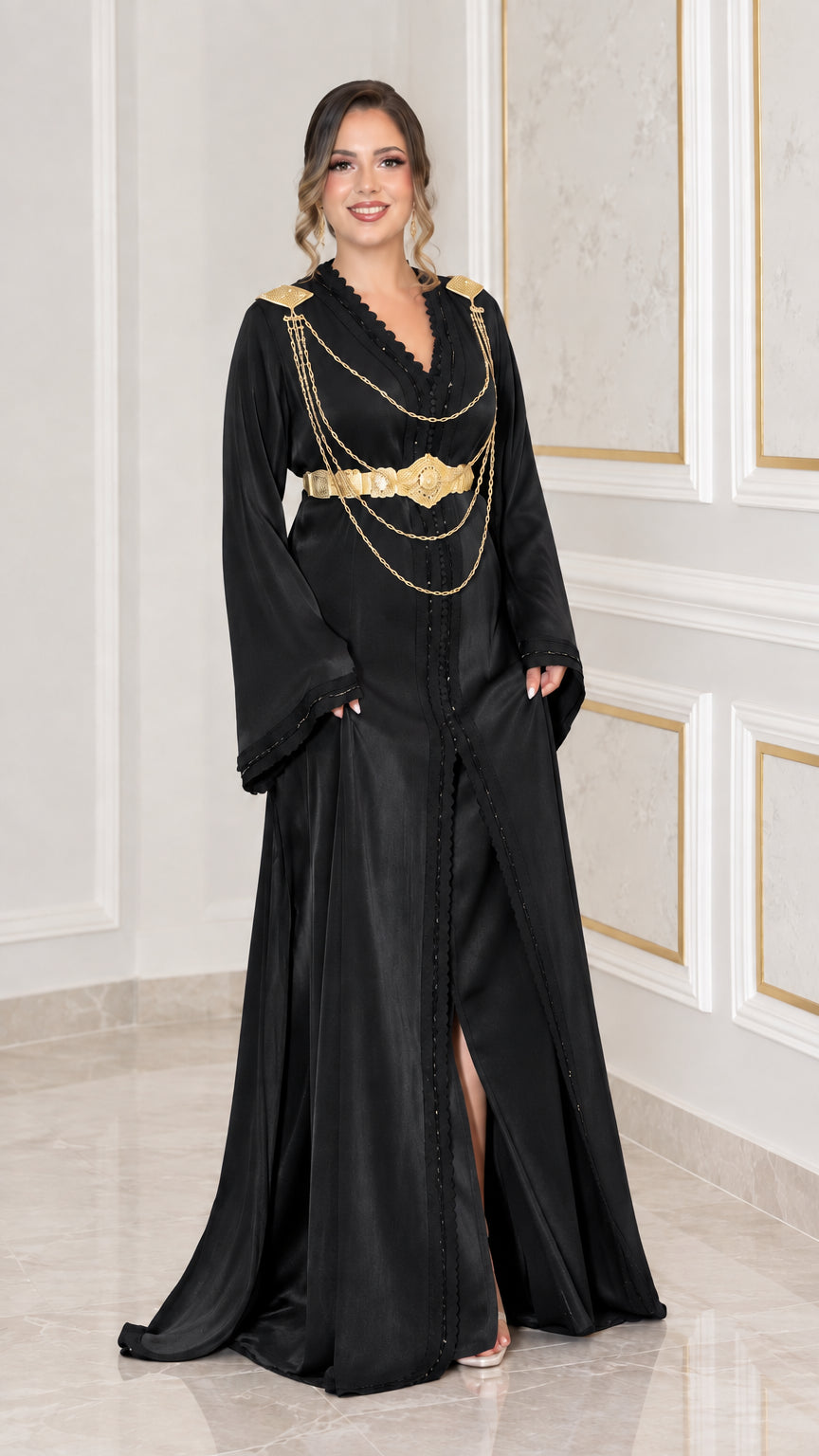 Black satin kaftan maxi dress with ornate gold belt and shoulder chain embellishments