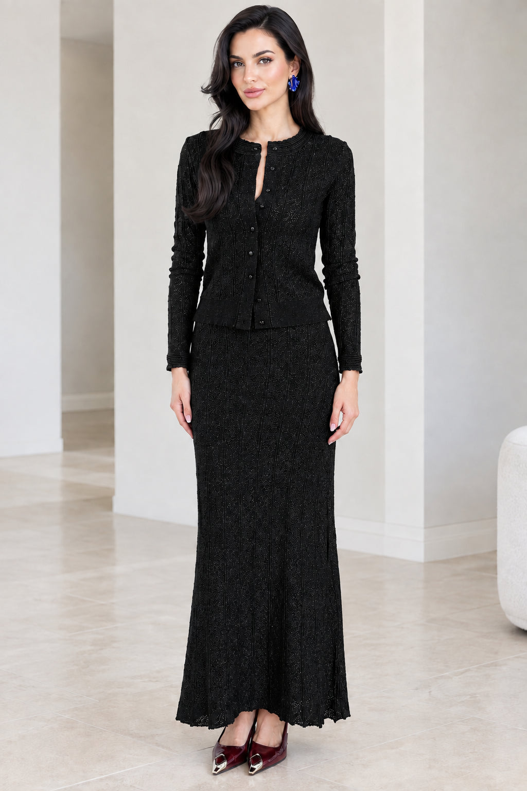 Front full-length view of black textured knit cardigan and maxi skirt set