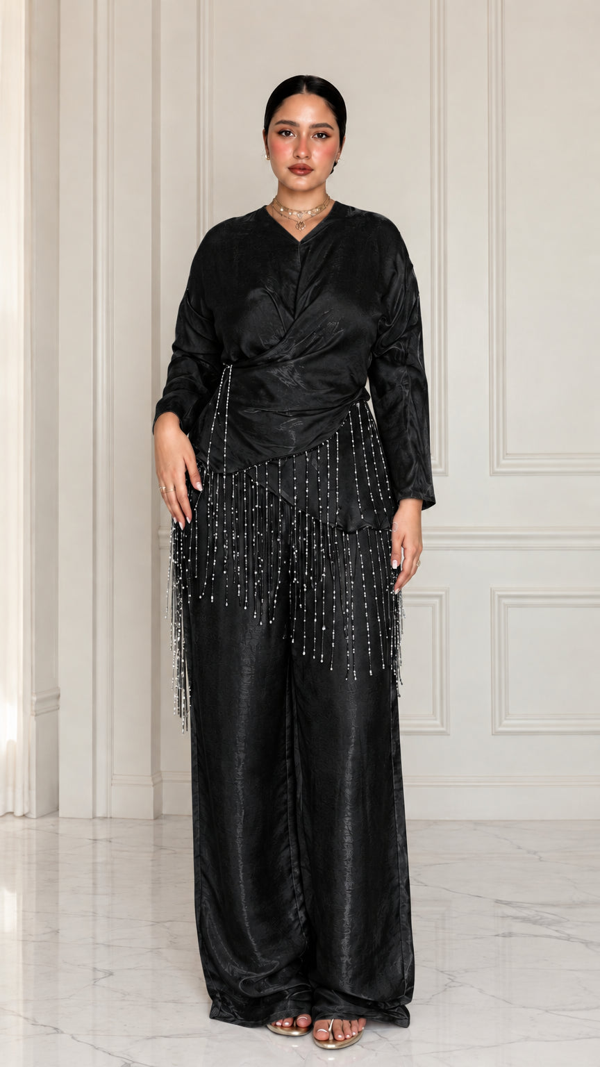 Full-length view of model wearing Black satin draped two-piece set with beaded trim