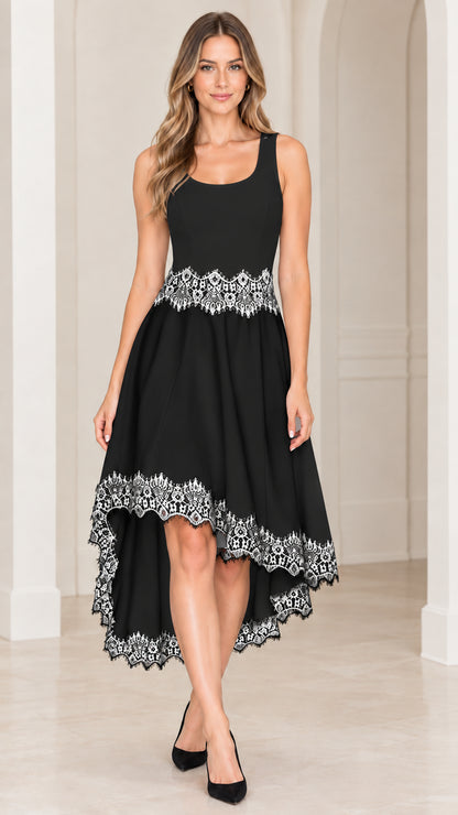 Front view of black sleeveless high-low cocktail dress with white lace detailing