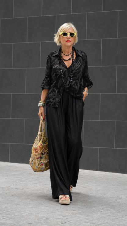 Front view of black printed blouse with black wide-leg pants set