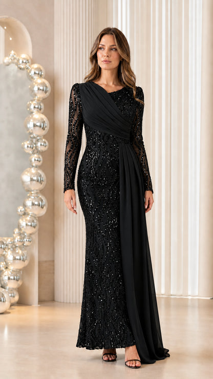 Front view of woman wearing classic black sequined long sleeve evening gown with chiffon drape