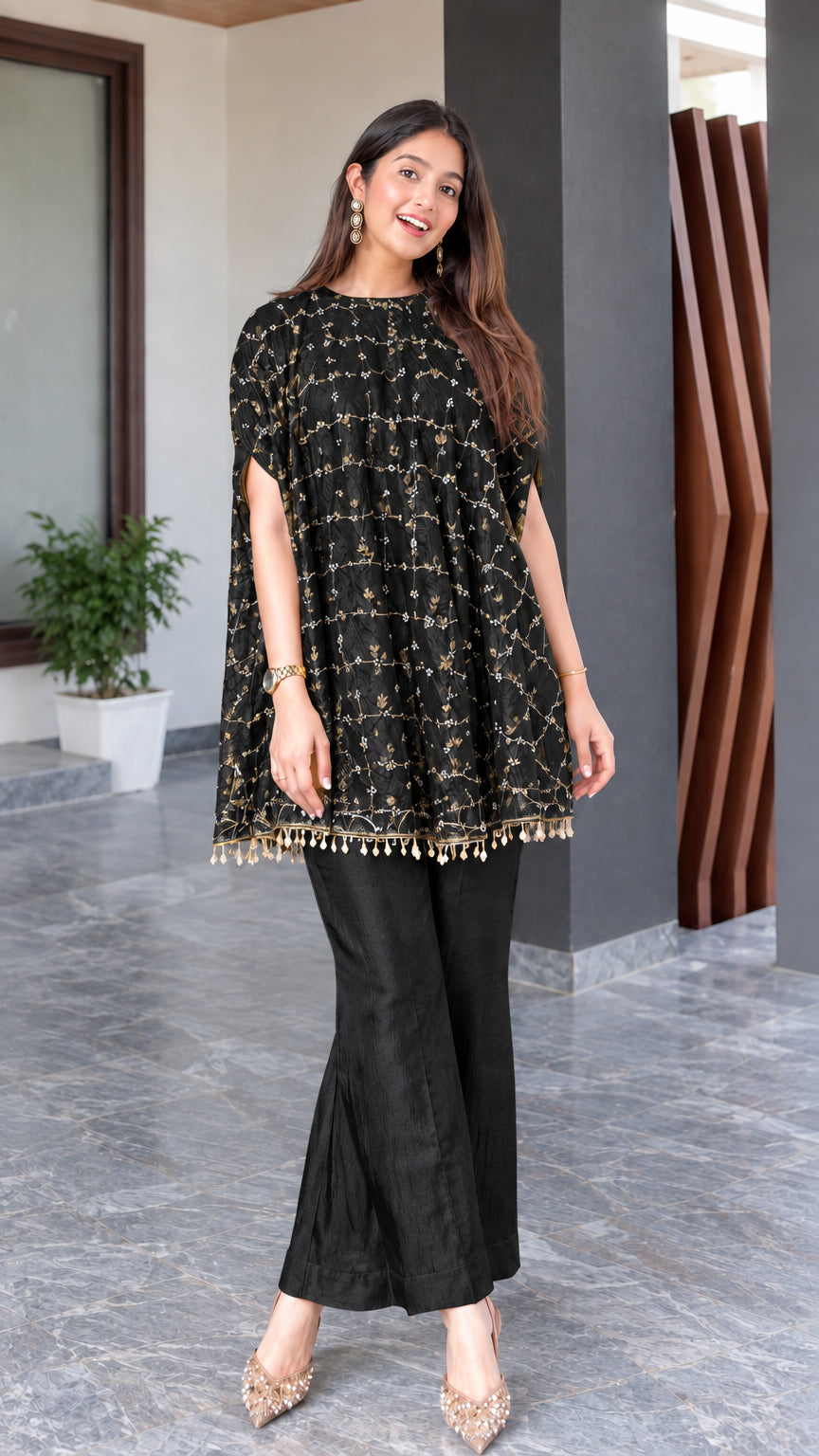 Model wearing black embroidered cape tunic and matching flared trousers