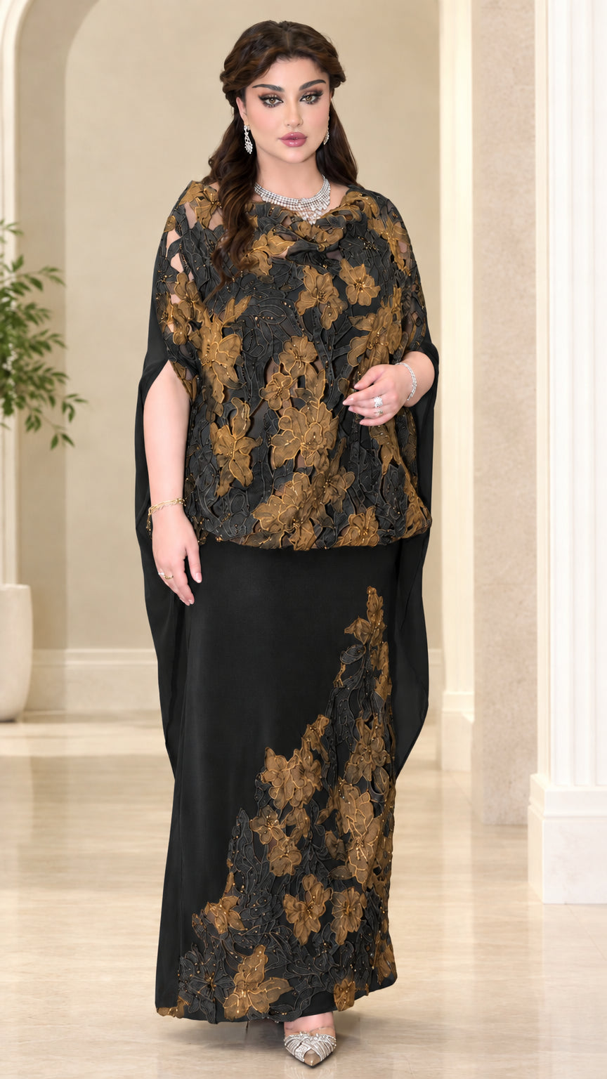 Model wearing black formal evening dress with golden floral lace cape