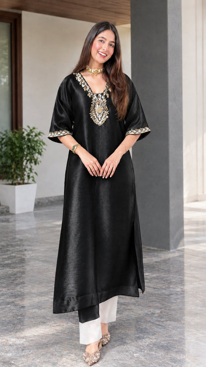 Front view of black embroidered silk blend tunic kurta paired with white trousers