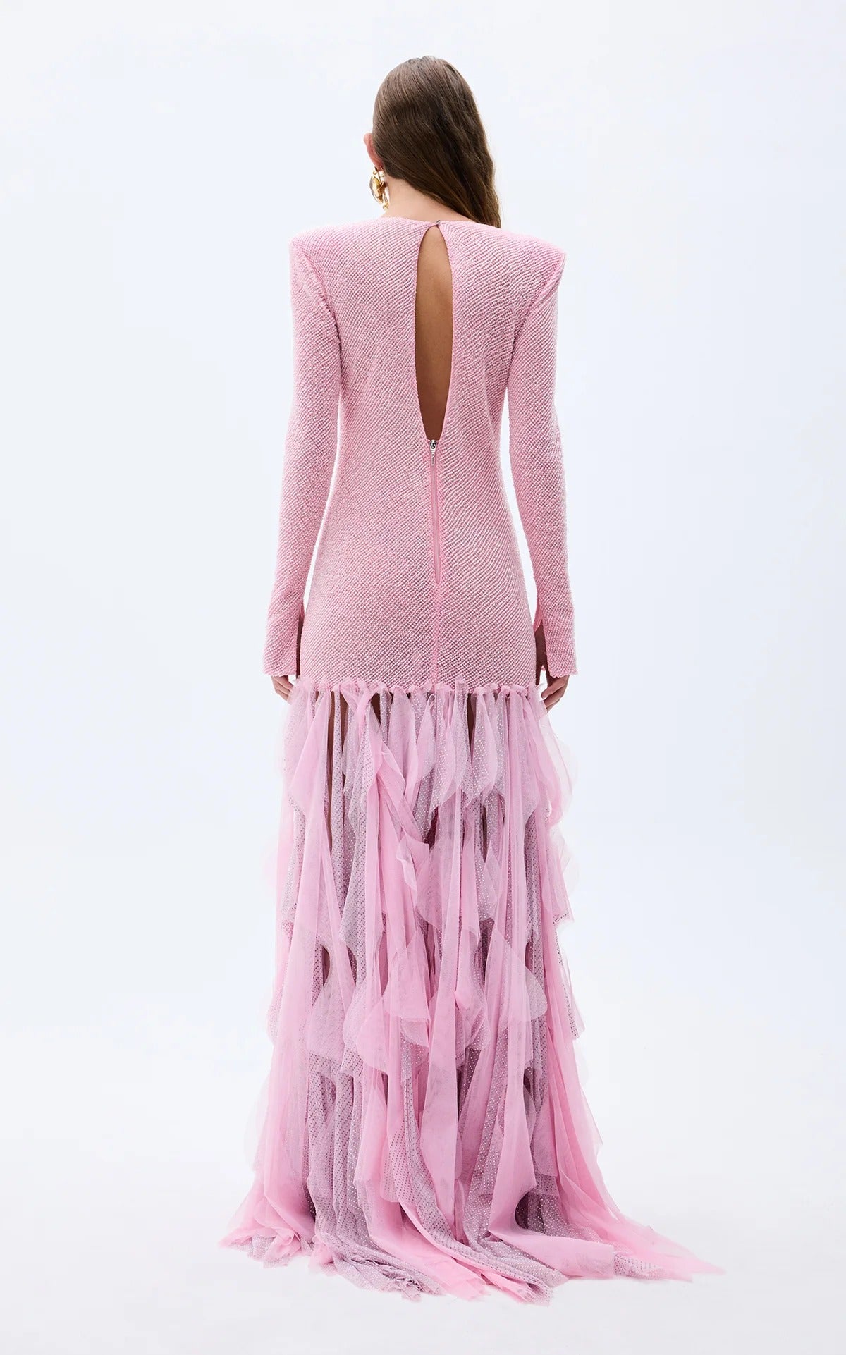 Back view of blush pink long-sleeve textured gown with open back and ruffle hem