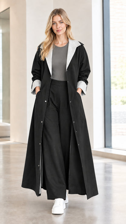 Model wearing black maxi duster coat with contrast grey lapel