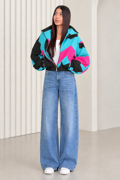 Woman wearing black and turquoise contrast colorblock retro windbreaker jacket