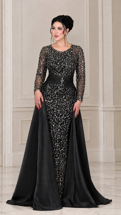 Front view of the black sequin long sleeve evening gown with matching black satin overskirt