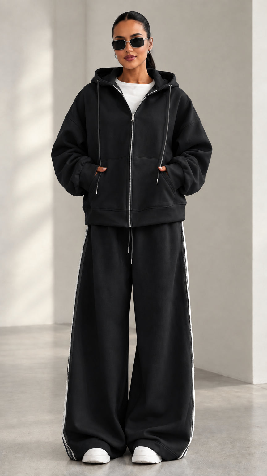 Model wearing Black zip-up hoodie and matching wide-leg track pants set