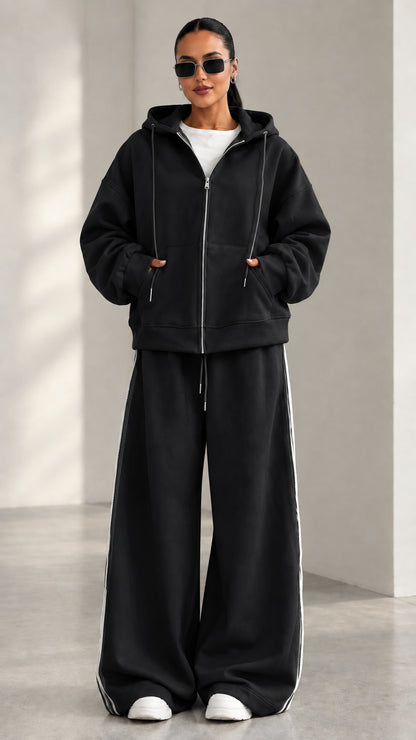 Model wearing Black zip-up hoodie and matching wide-leg track pants set