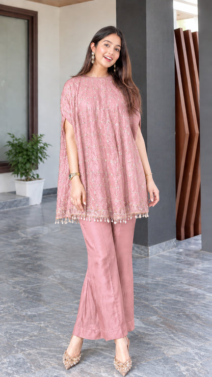 Model wearing dusty pink embroidered cape tunic and matching flared trousers