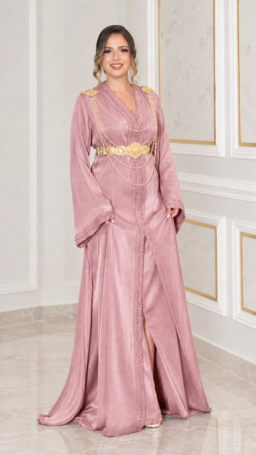 Dusty pink satin kaftan dress styled with gold-tone waist belt and shoulder chains