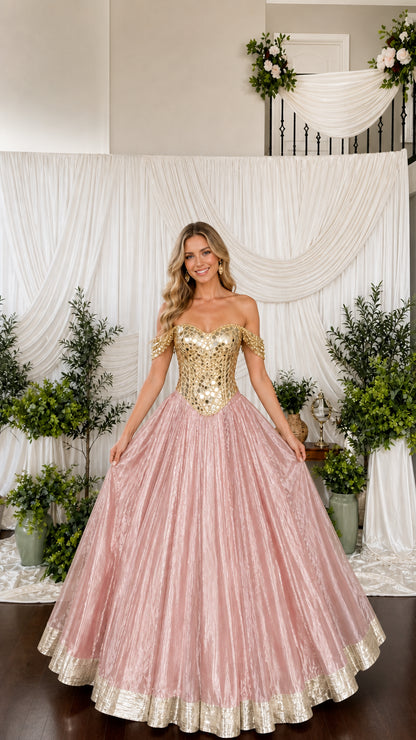 Model wearing blush pink pleated shimmer ball gown with gold mirrored corset