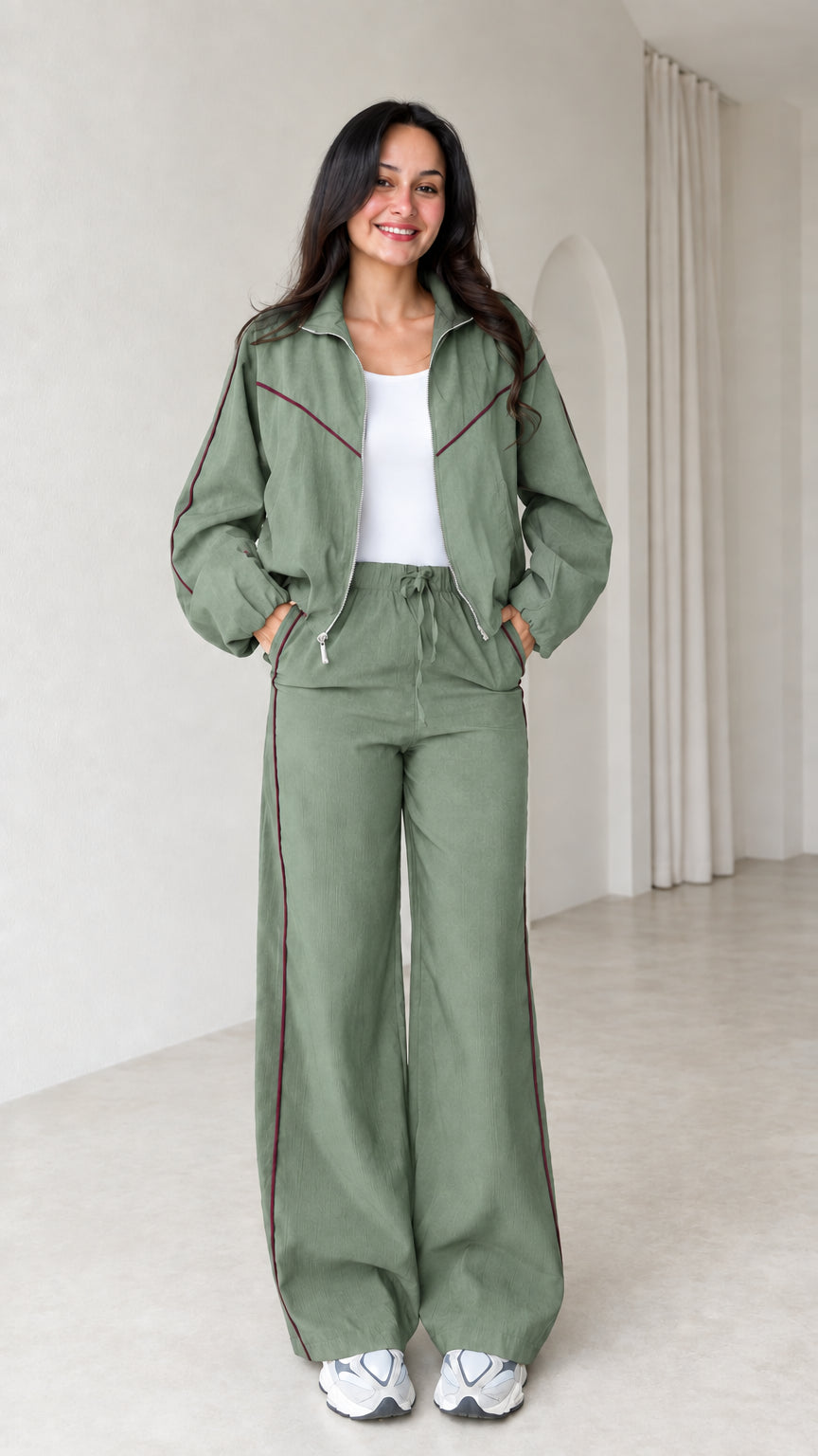 Model wearing sage green zip track jacket and wide leg pants set