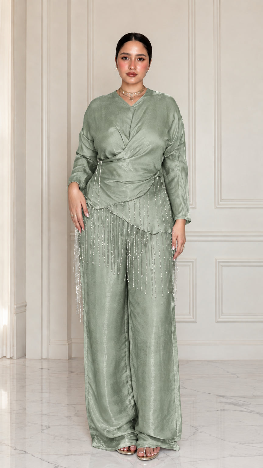 Full-length view of model wearing Sage Green satin draped two-piece set with beaded trim