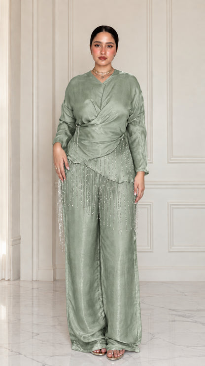 Full-length view of model wearing Sage Green satin draped two-piece set with beaded trim