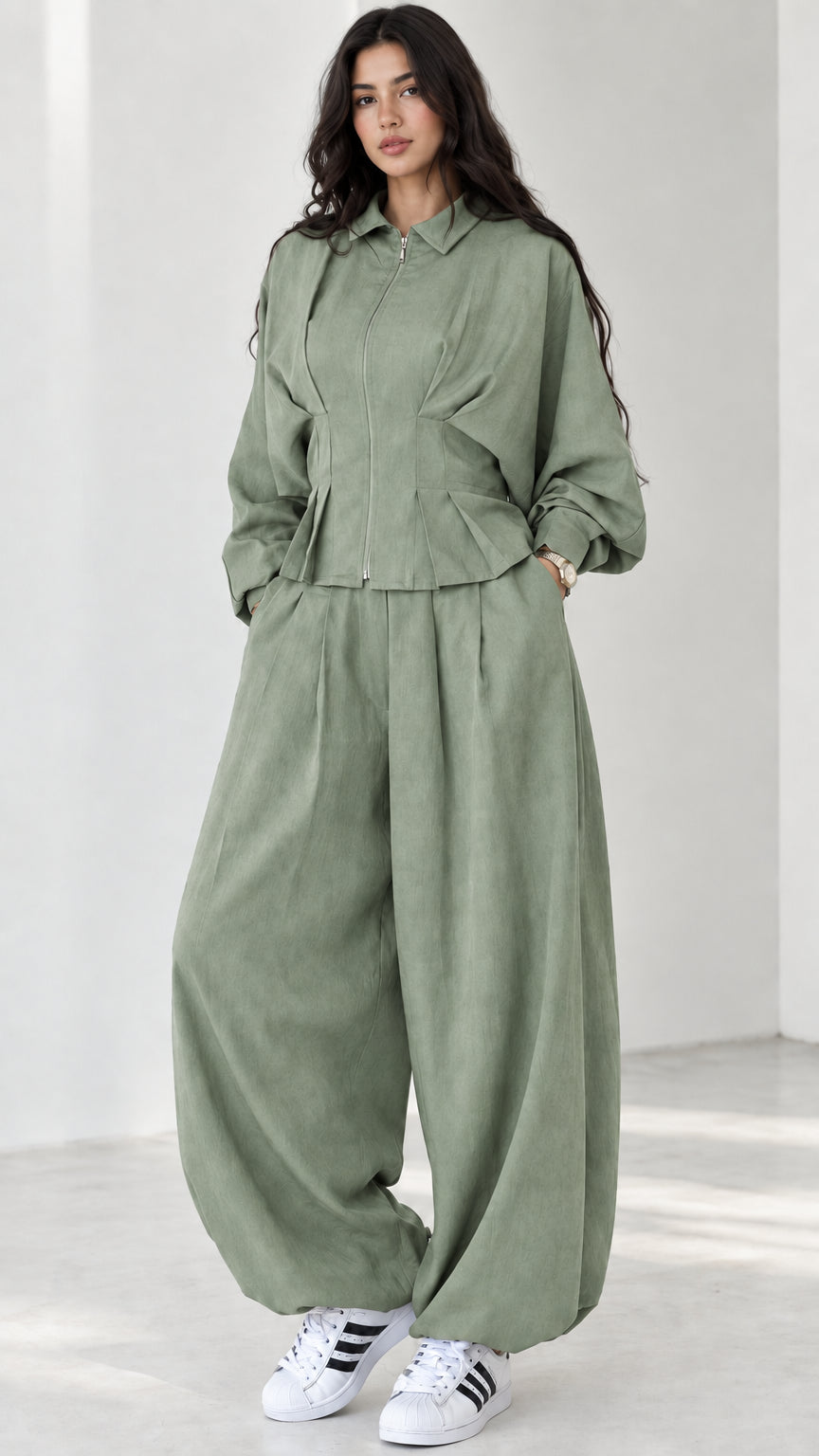 Model wearing sage green matching two-piece pant and jacket set