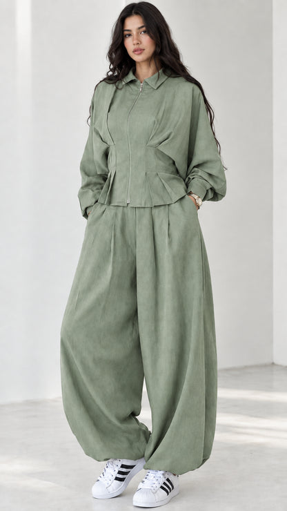 Model wearing sage green matching two-piece pant and jacket set