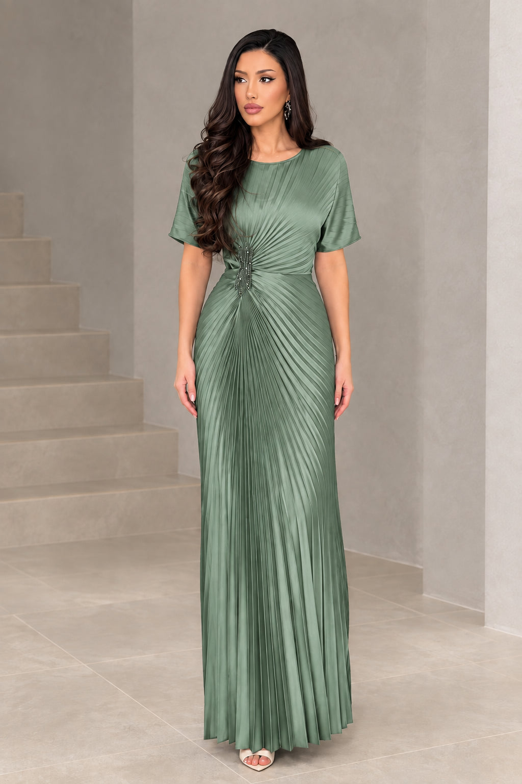 Front full-length view of woman wearing sage green pleated formal dress