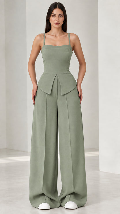 Full front view of model wearing sage green square neck peplum wide leg jumpsuit