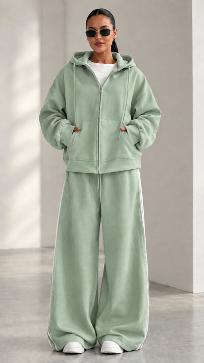 Model wearing Sage Green zip-up hoodie and matching wide-leg track pants set