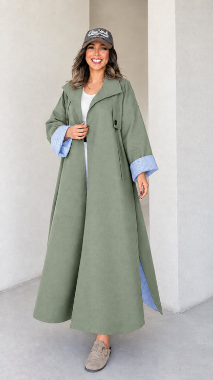 Full-length studio shot of woman wearing sage green maxi trench duster coat