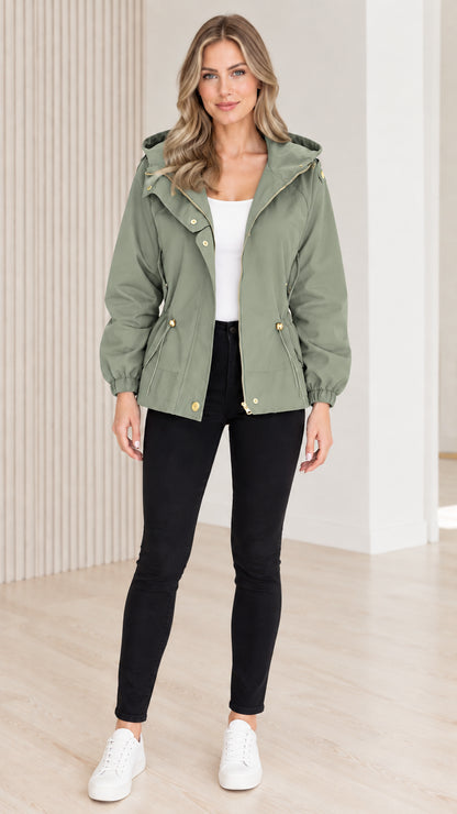Front view of model wearing sage green hooded drawstring utility jacket
